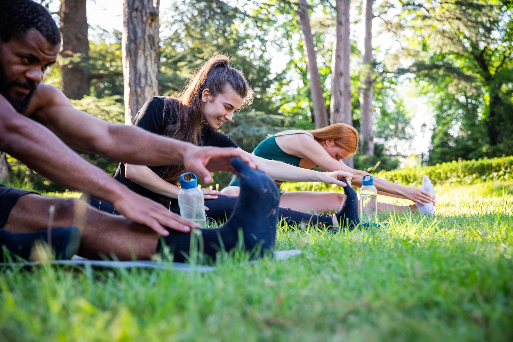 Friends stretching together outdoors